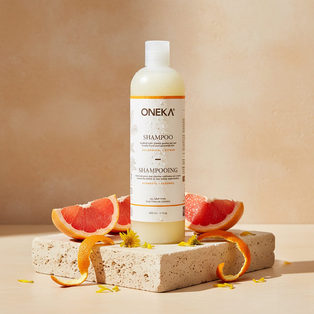 Oneka Goldenseal and Citrus shampoo bottle with grapefruit slices